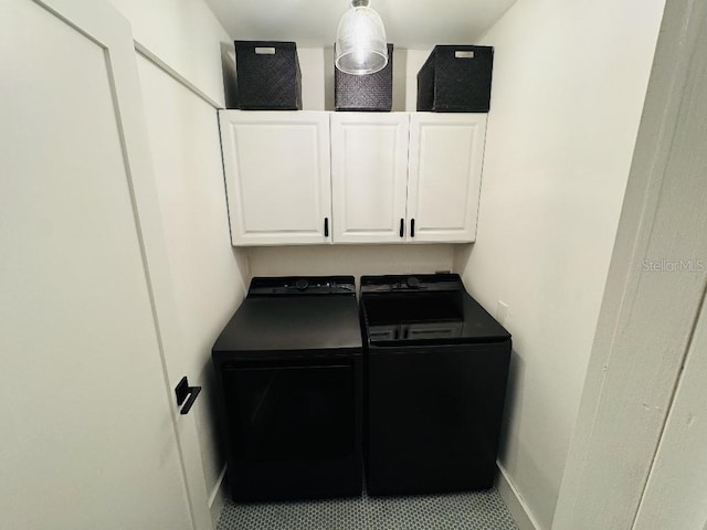 laundry room with cabinets and separate washer and dryer