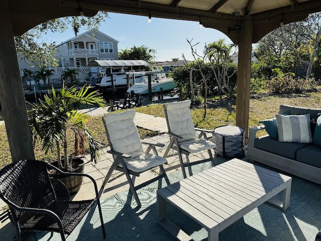 view of patio with a gazebo, a dock, and an outdoor hangout area