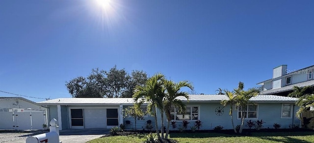 ranch-style home with a front lawn