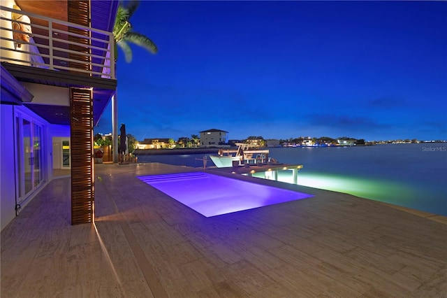 pool at dusk with a water view