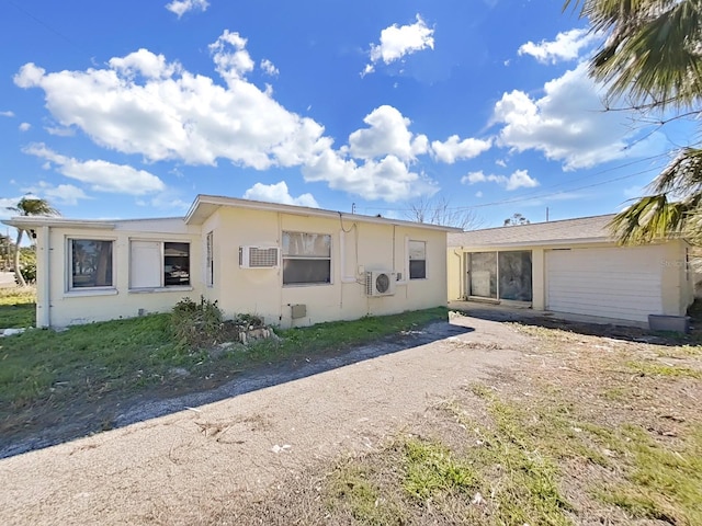 14140 E Parsley Dr, Madeira Beach, FL 33708 - view of front of property featuring stucco siding and a wall mounted AC