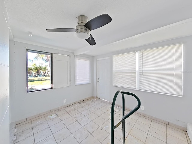 unfurnished room featuring ceiling fan and light tile patterned flooring