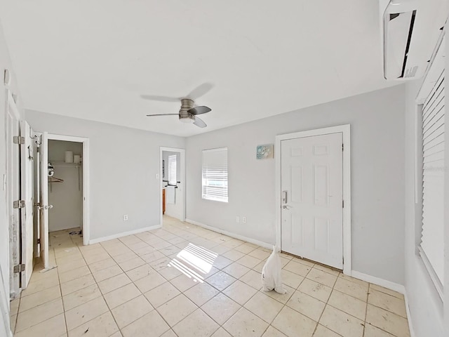 entryway featuring light tile patterned floors and ceiling fan