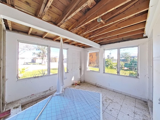 unfurnished sunroom with lofted ceiling