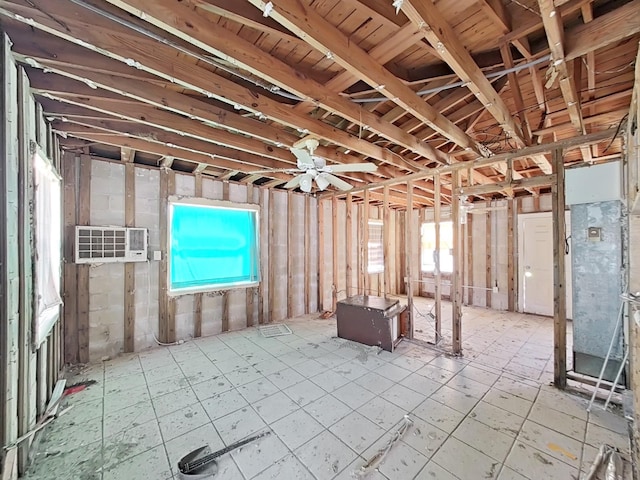 miscellaneous room with a wall unit AC, a wealth of natural light, and ceiling fan