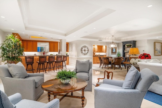 living room featuring a chandelier and a tray ceiling