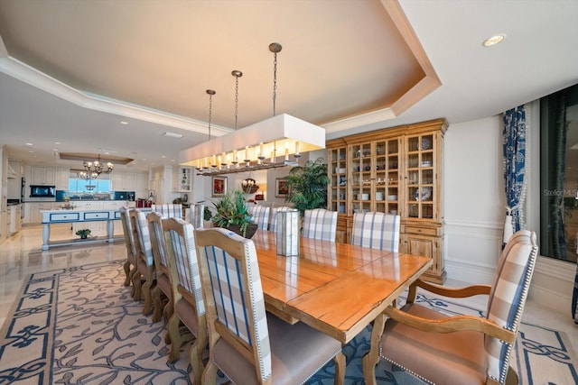 dining space with a chandelier and crown molding