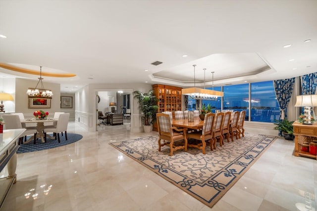 dining room featuring a chandelier and a tray ceiling