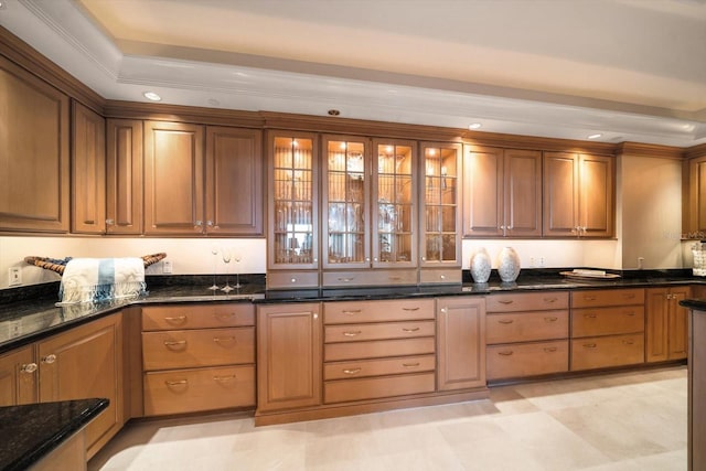 kitchen with dark stone countertops and ornamental molding