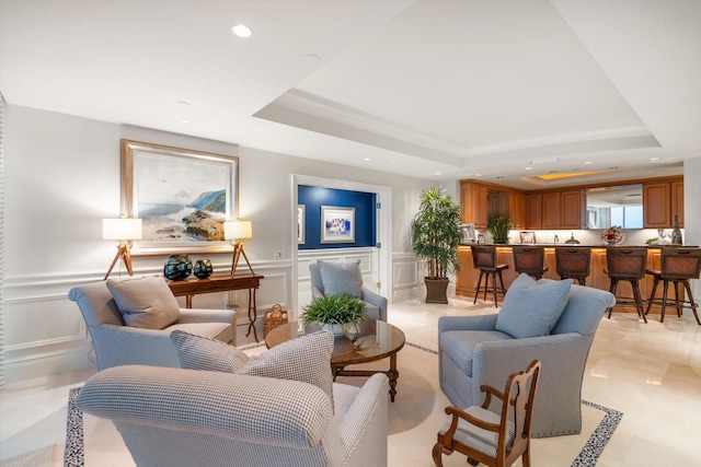 living room with a tray ceiling