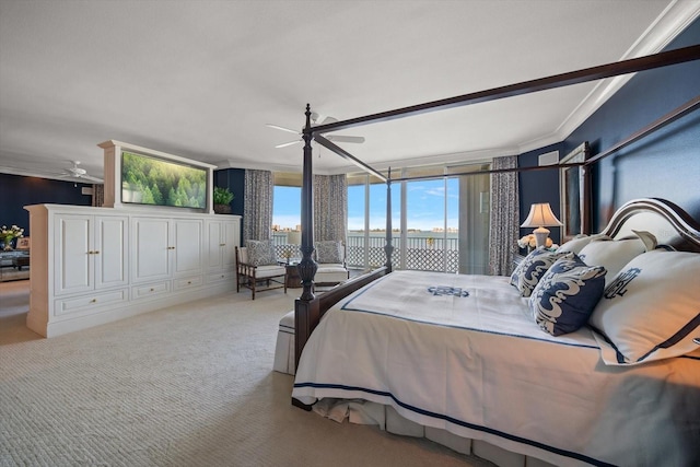 carpeted bedroom featuring ceiling fan and crown molding