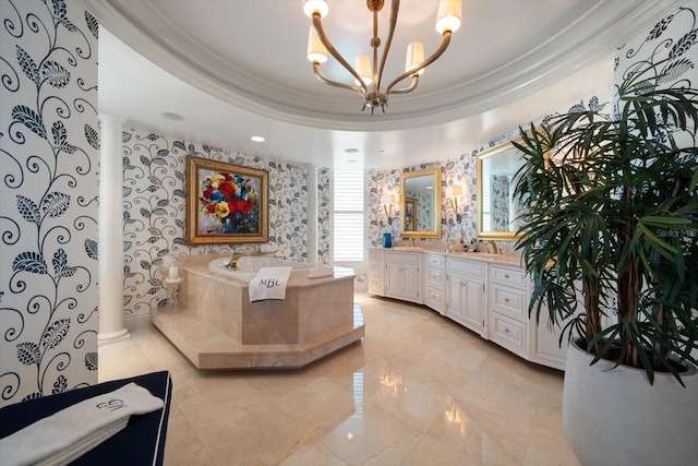 bathroom with a washtub, a raised ceiling, ornate columns, and vanity