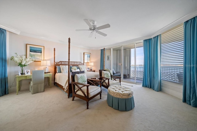 carpeted bedroom with ceiling fan, crown molding, and access to outside