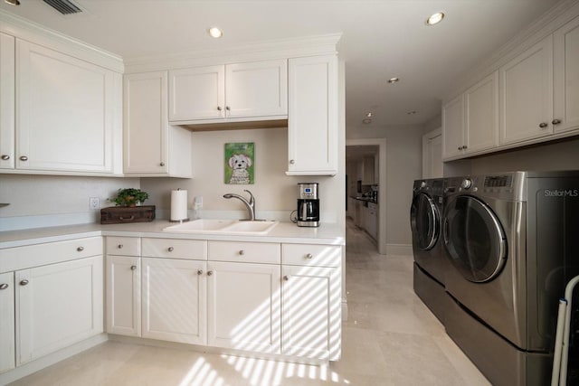 washroom with separate washer and dryer, sink, and light tile patterned floors