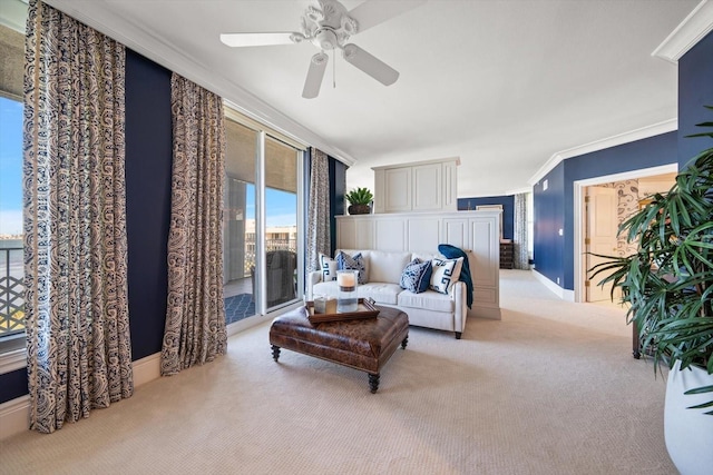 living room featuring light colored carpet, ceiling fan, and ornamental molding