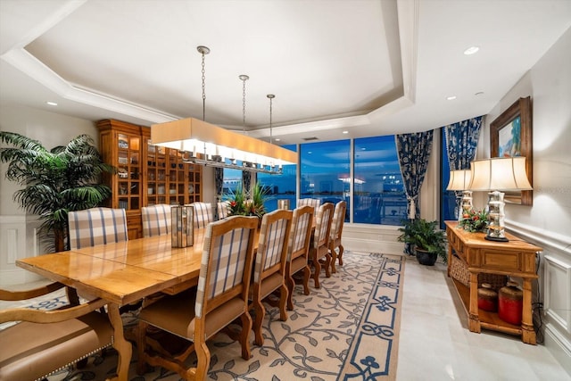 dining area with a raised ceiling, a notable chandelier, and recessed lighting