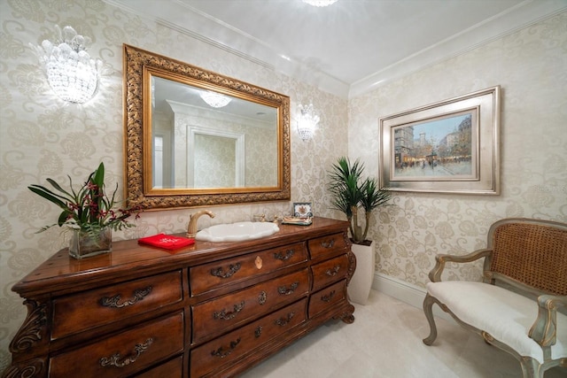 bathroom with baseboards, ornamental molding, vanity, and wallpapered walls