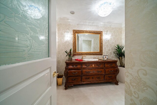 bathroom featuring wallpapered walls and vanity