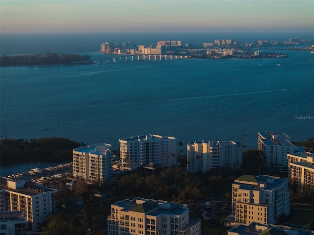 aerial view at dusk with a view of city and a water view