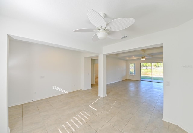 unfurnished room with ceiling fan and light tile patterned flooring