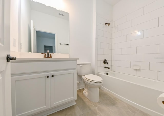 full bathroom with tile patterned flooring, toilet, vanity, and tiled shower / bath