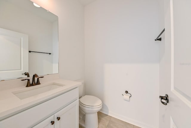 bathroom with tile patterned flooring, vanity, and toilet