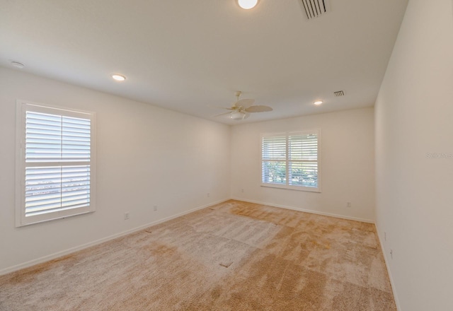 carpeted empty room featuring ceiling fan