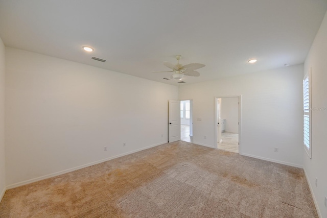 unfurnished room with ceiling fan and light colored carpet