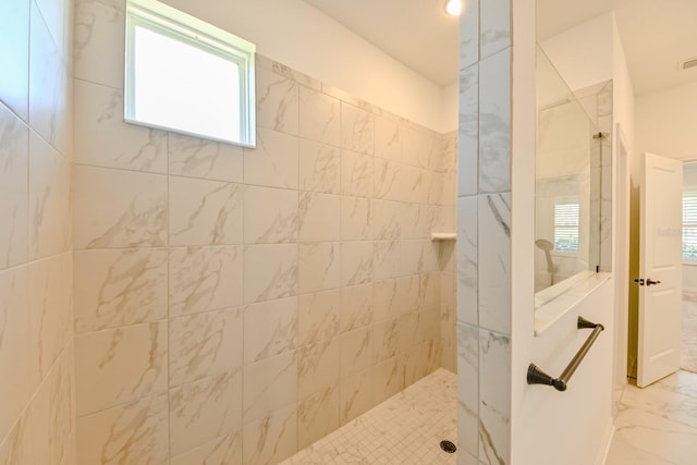 bathroom featuring tiled shower