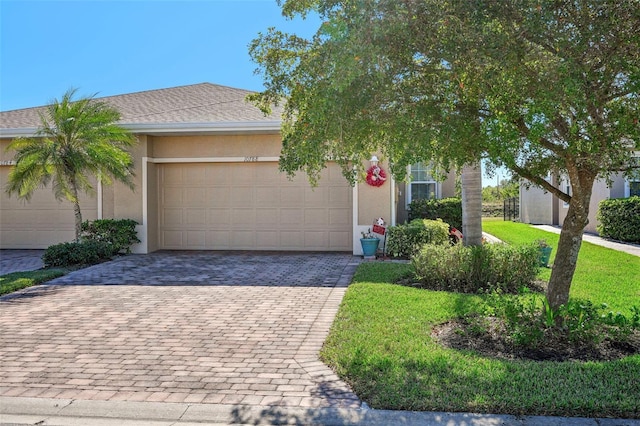 view of front of home with a front lawn and a garage