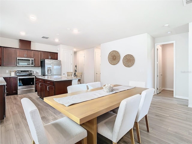 dining area with light hardwood / wood-style flooring