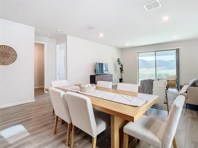 dining area with light hardwood / wood-style flooring