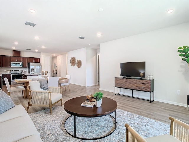 living room with light hardwood / wood-style floors