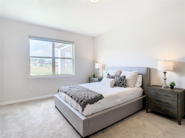 bedroom featuring light carpet