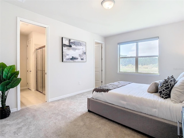 carpeted bedroom featuring ensuite bathroom