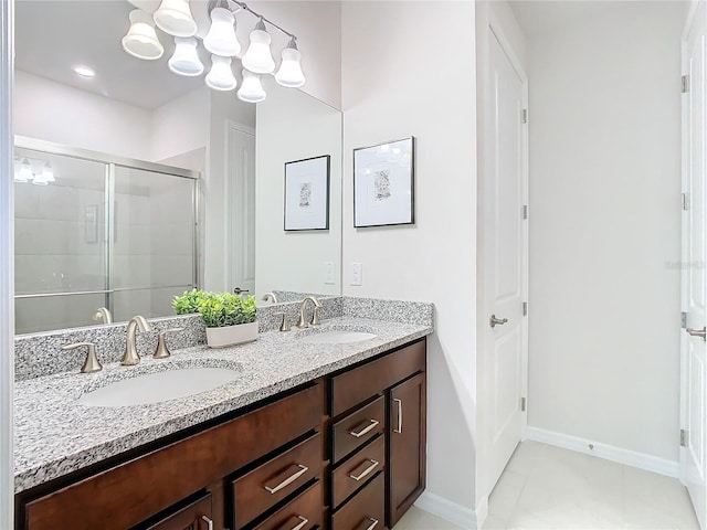 bathroom with tile patterned floors, vanity, and a shower with door