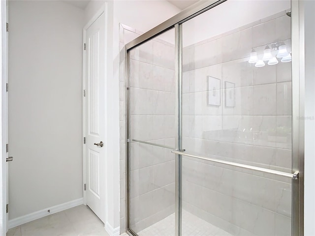 bathroom featuring tile patterned floors and a shower with door