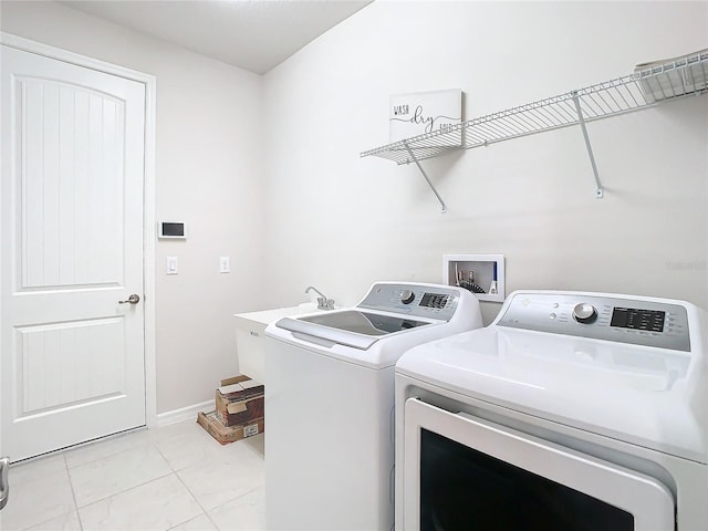 washroom featuring independent washer and dryer and light tile patterned floors