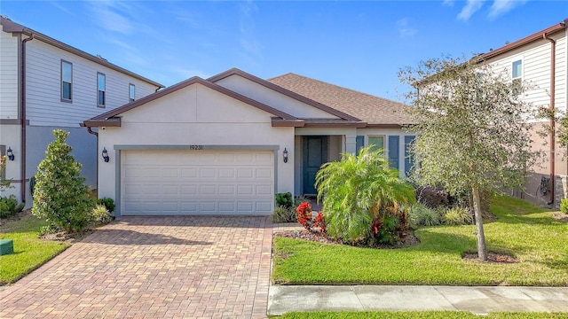 view of front of home featuring a garage and a front lawn