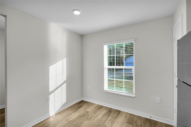 spare room featuring light hardwood / wood-style floors