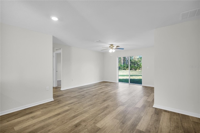 empty room featuring hardwood / wood-style flooring and ceiling fan