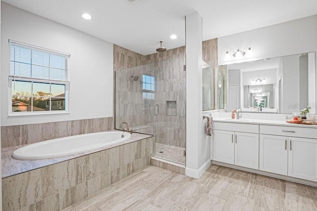 bathroom featuring separate shower and tub and vanity