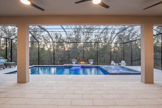 pool at dusk with a lanai, a patio, and an in ground hot tub