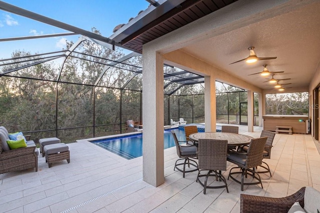 view of pool with a lanai, ceiling fan, a jacuzzi, and a patio