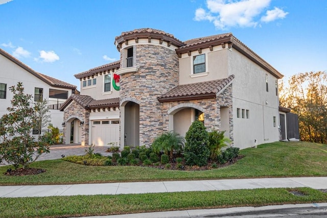 mediterranean / spanish home featuring a garage and a front yard