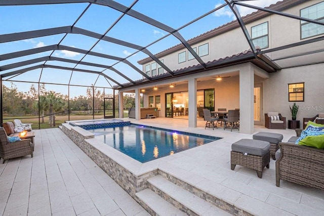 view of pool with ceiling fan, a jacuzzi, a patio area, outdoor lounge area, and a lanai