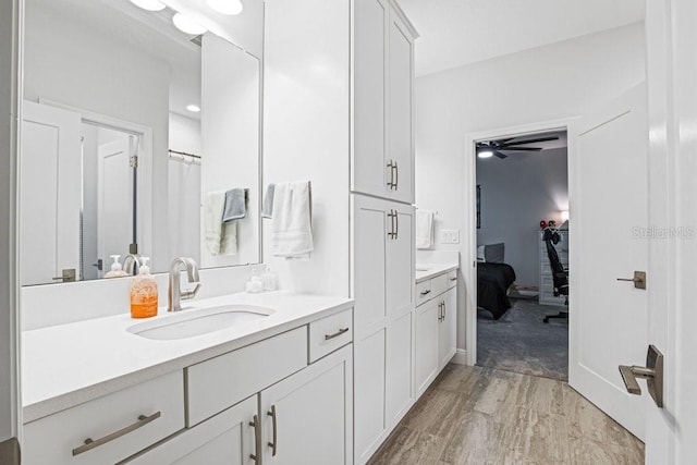 13019 Paddock Wood Pl, Riverview, FL 33579 - ensuite bathroom featuring vanity, wood finished floors, and a ceiling fan