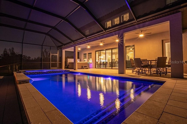 13019 Paddock Wood Pl, Riverview, FL 33579 - pool at night with an outdoor hot tub, an outdoor pool, a patio area, and a ceiling fan