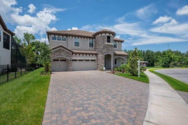 13019 Paddock Wood Pl, Riverview, FL 33579 - mediterranean / spanish house with a tile roof, stone siding, stucco siding, and driveway