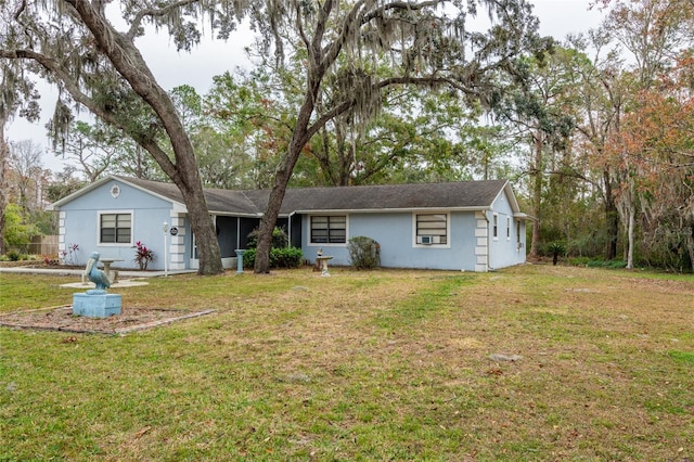 rear view of property with a lawn